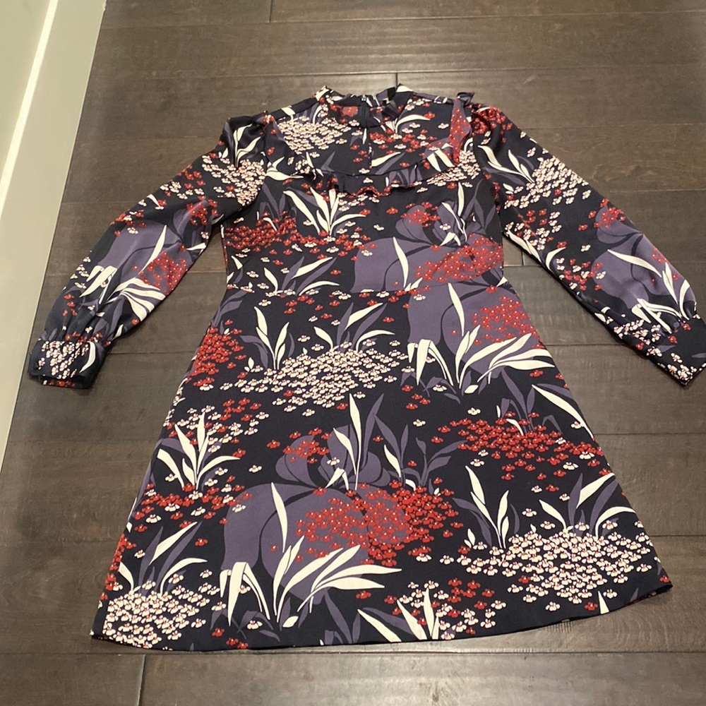 A-line patterned dress with ruffle bib detail.